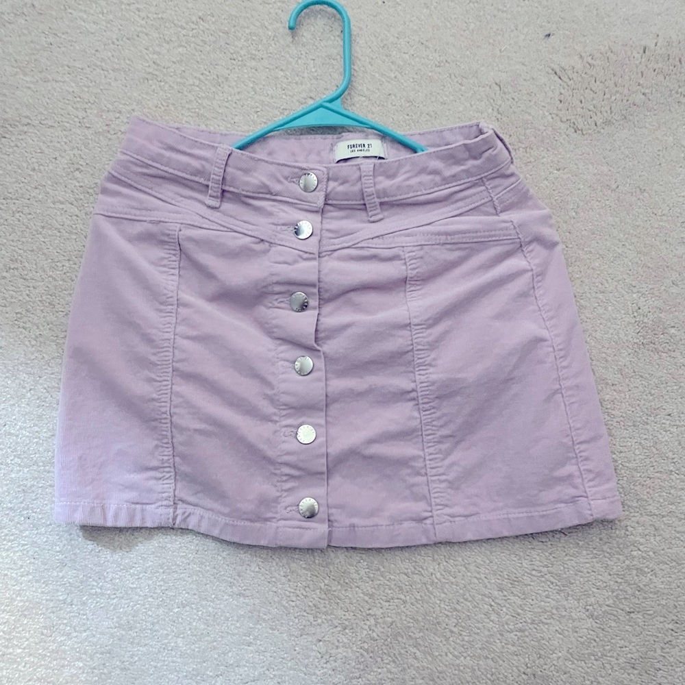 Pastel/Light Purple mini skirt with silver button details.